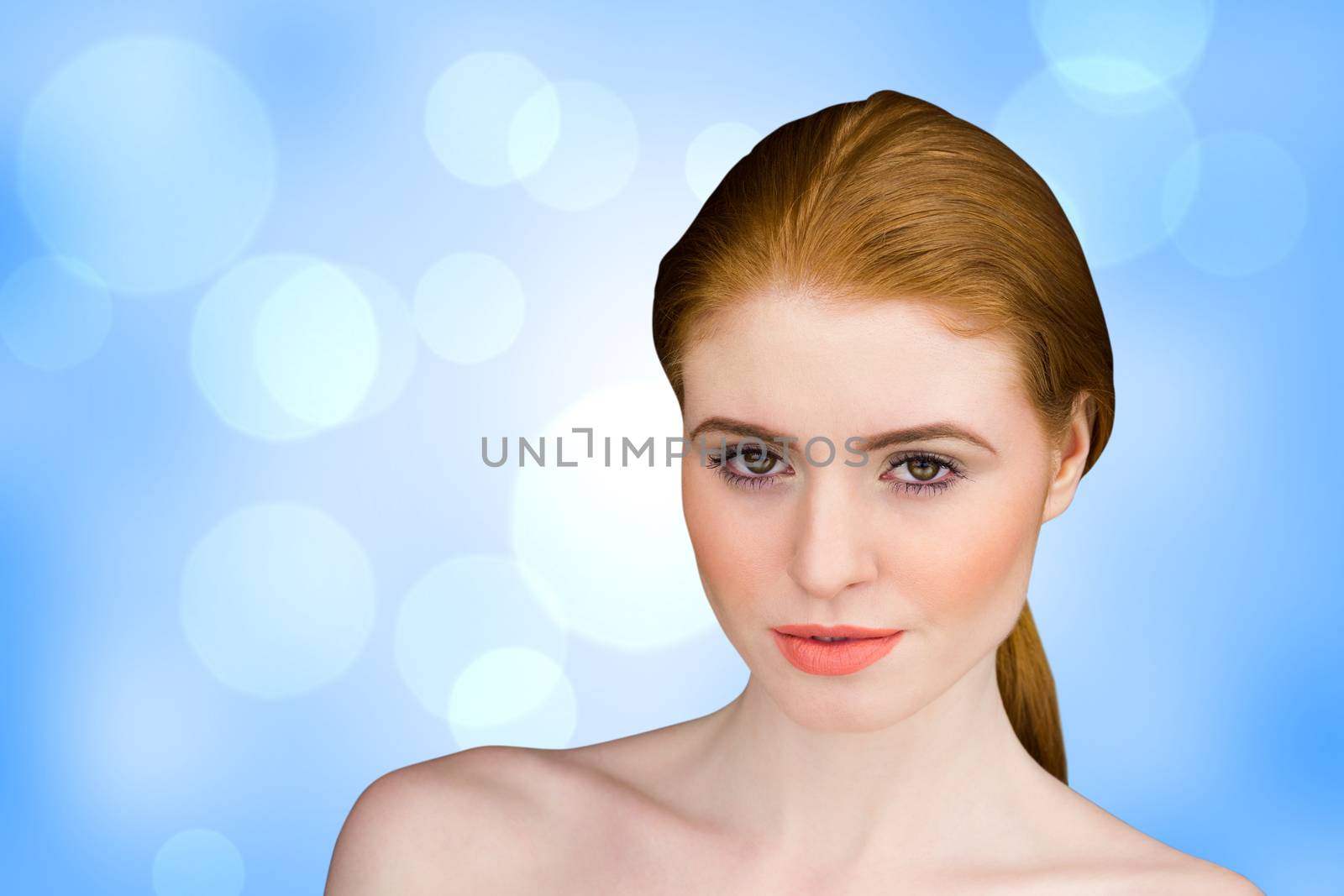 Beautiful redhead looking at camera against blue abstract light spot design