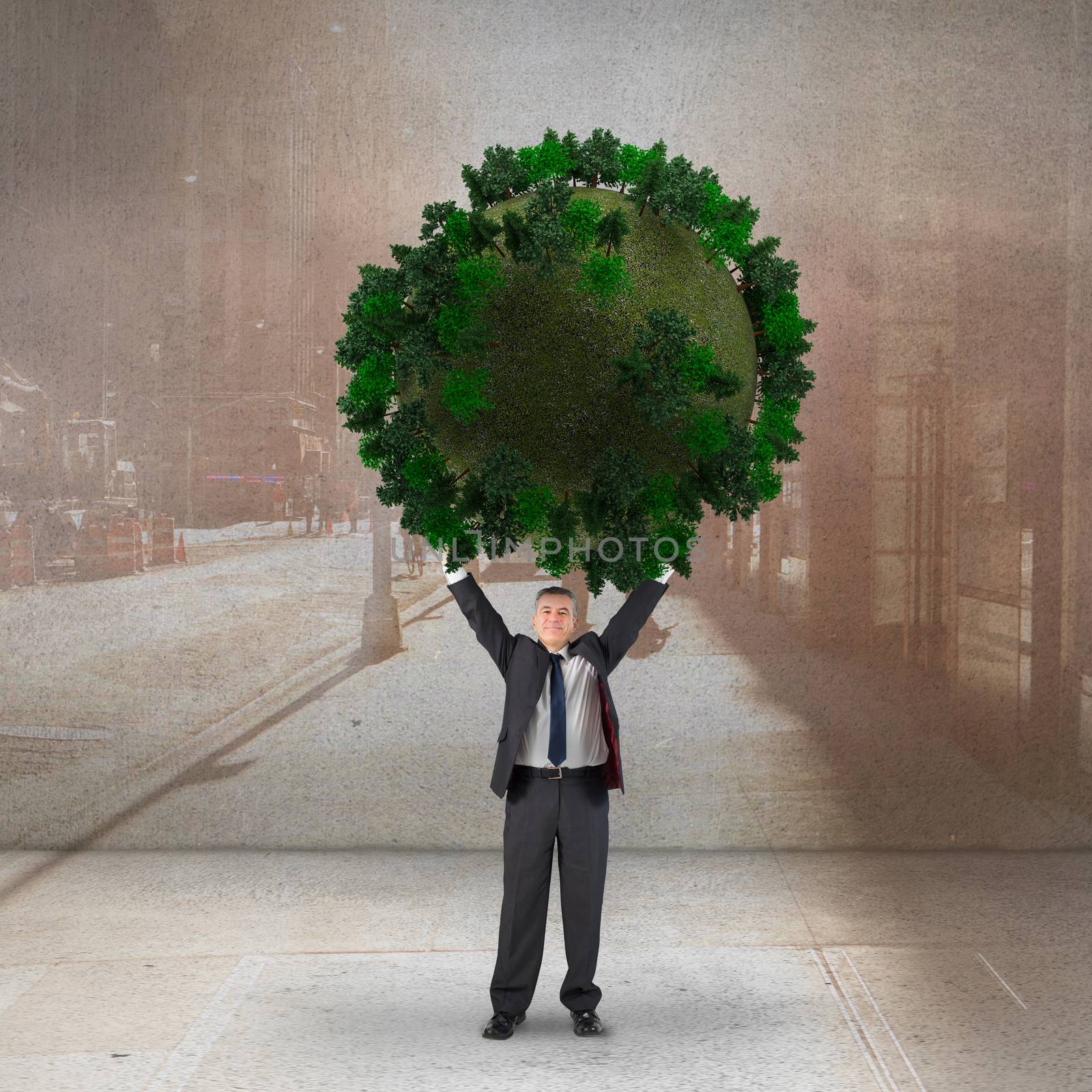 Composite image of businessman holding green sphere against urban projection on wall