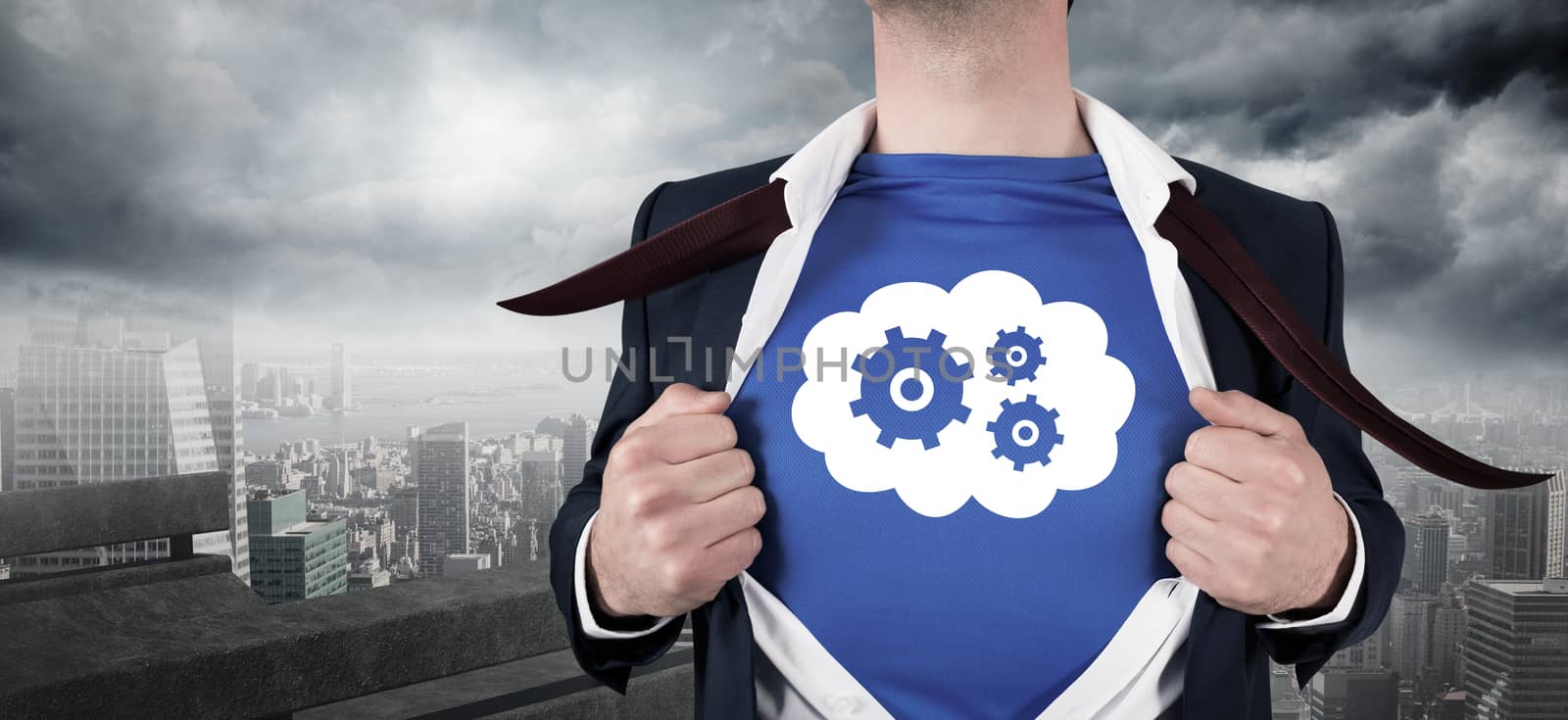 Composite image of businessman opening his shirt superhero style by Wavebreakmedia