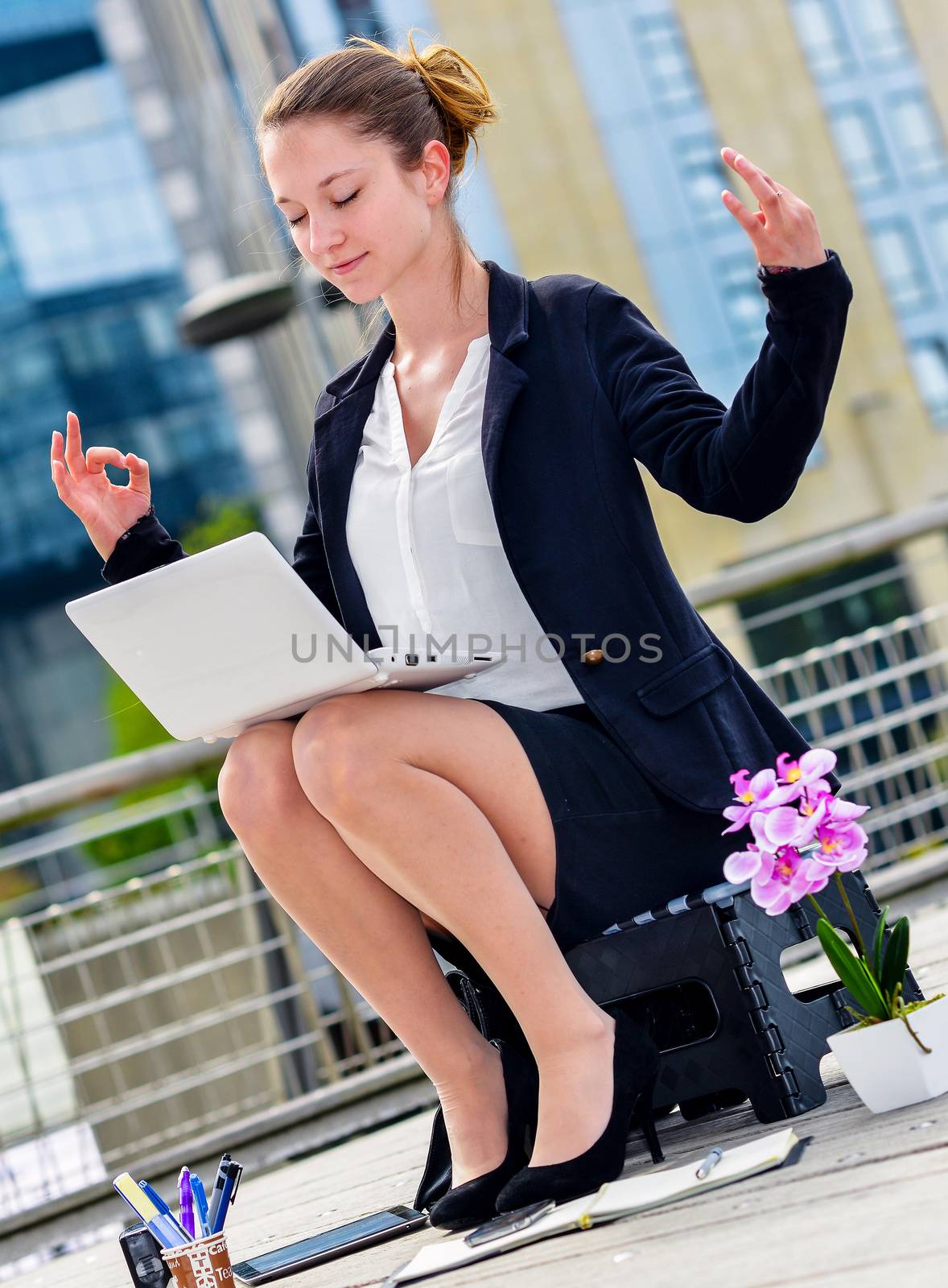 Junior executive of company doing yoga for relaxation