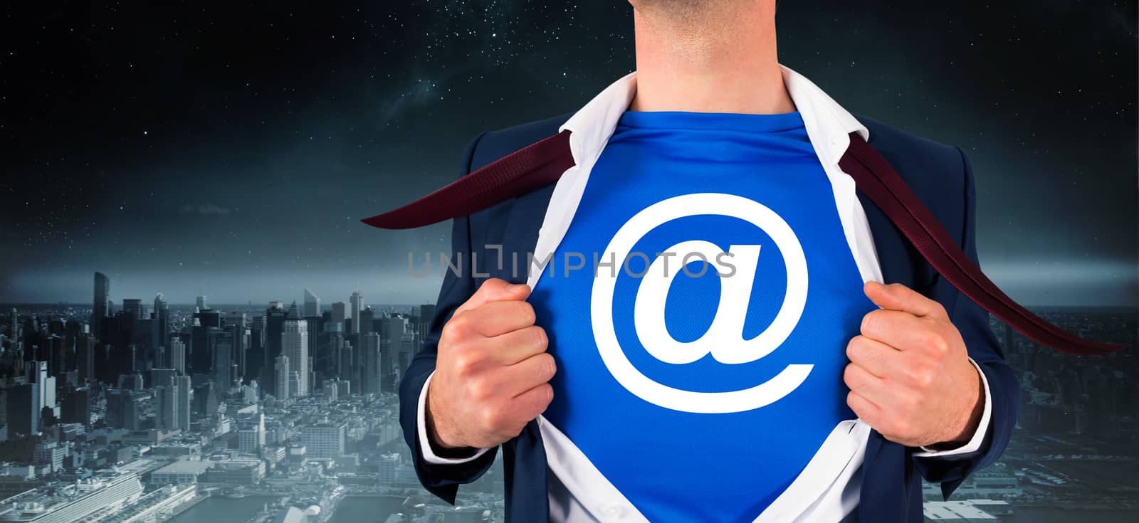 Composite image of businessman opening his shirt superhero style by Wavebreakmedia