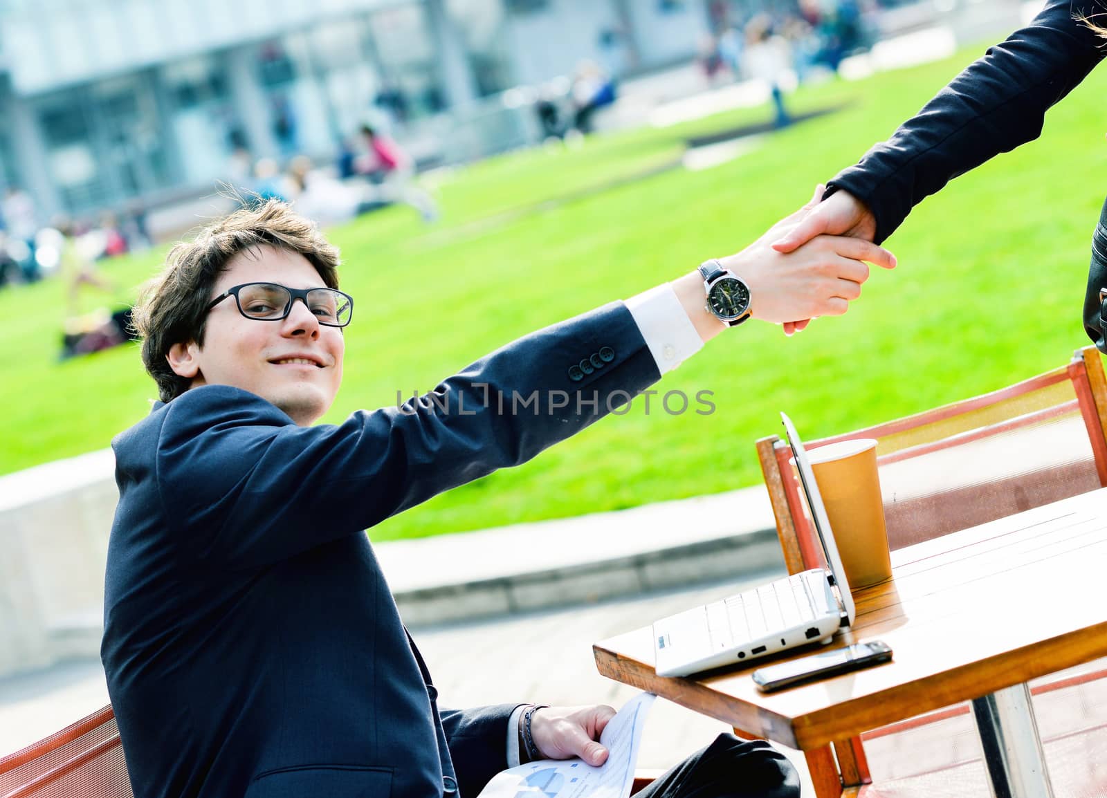 Junior executives dynamics shaking hands