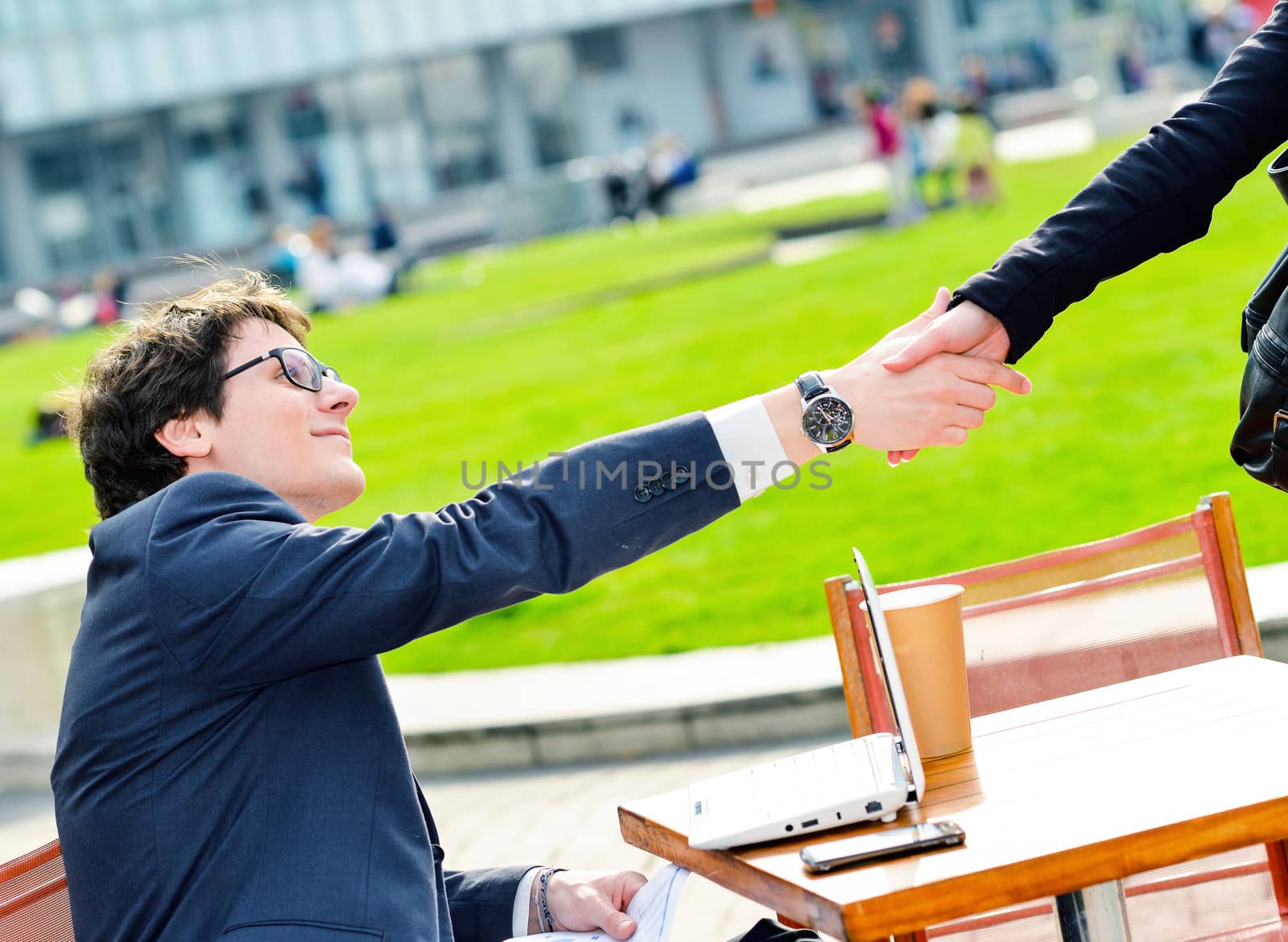 Junior executives dynamics shaking hands