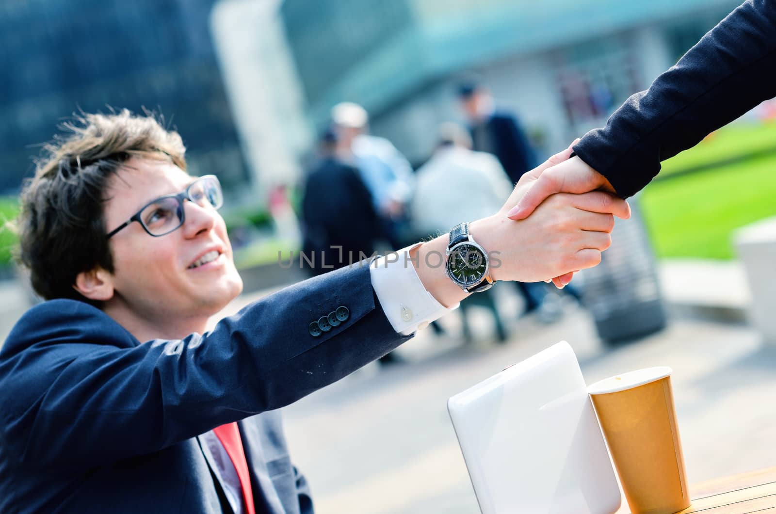 Junior executives dynamics shaking hands