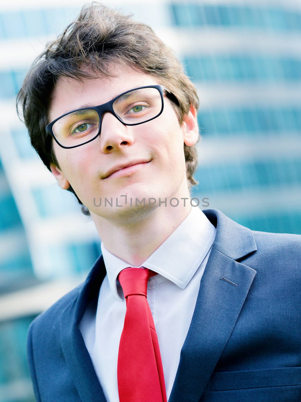 Outdoor portrait of a dynamic junior executive smiling