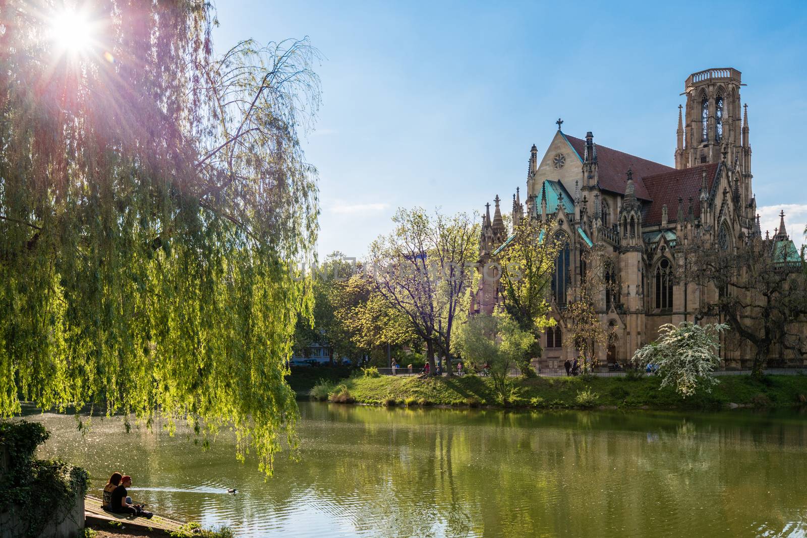 STUTTGART, GERMANY - APRIL 24, 2014: People are enjoying a great sunny spring day around Johanneskirche (St. Johns Church) at Feuersee (fire pond) on April, 24,2014 in Stuttgart, Germany.