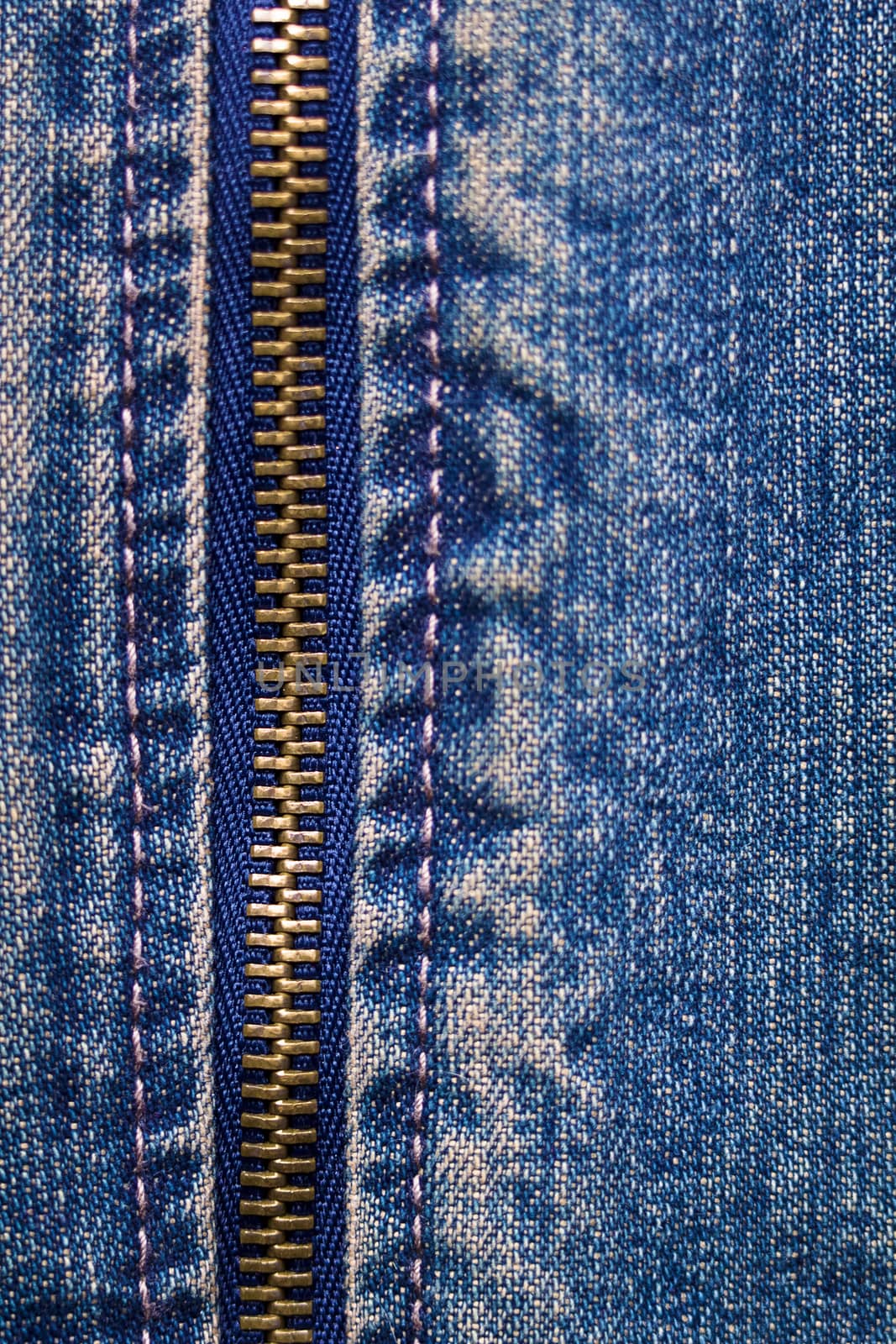 metal zipper with denim. close up. macro