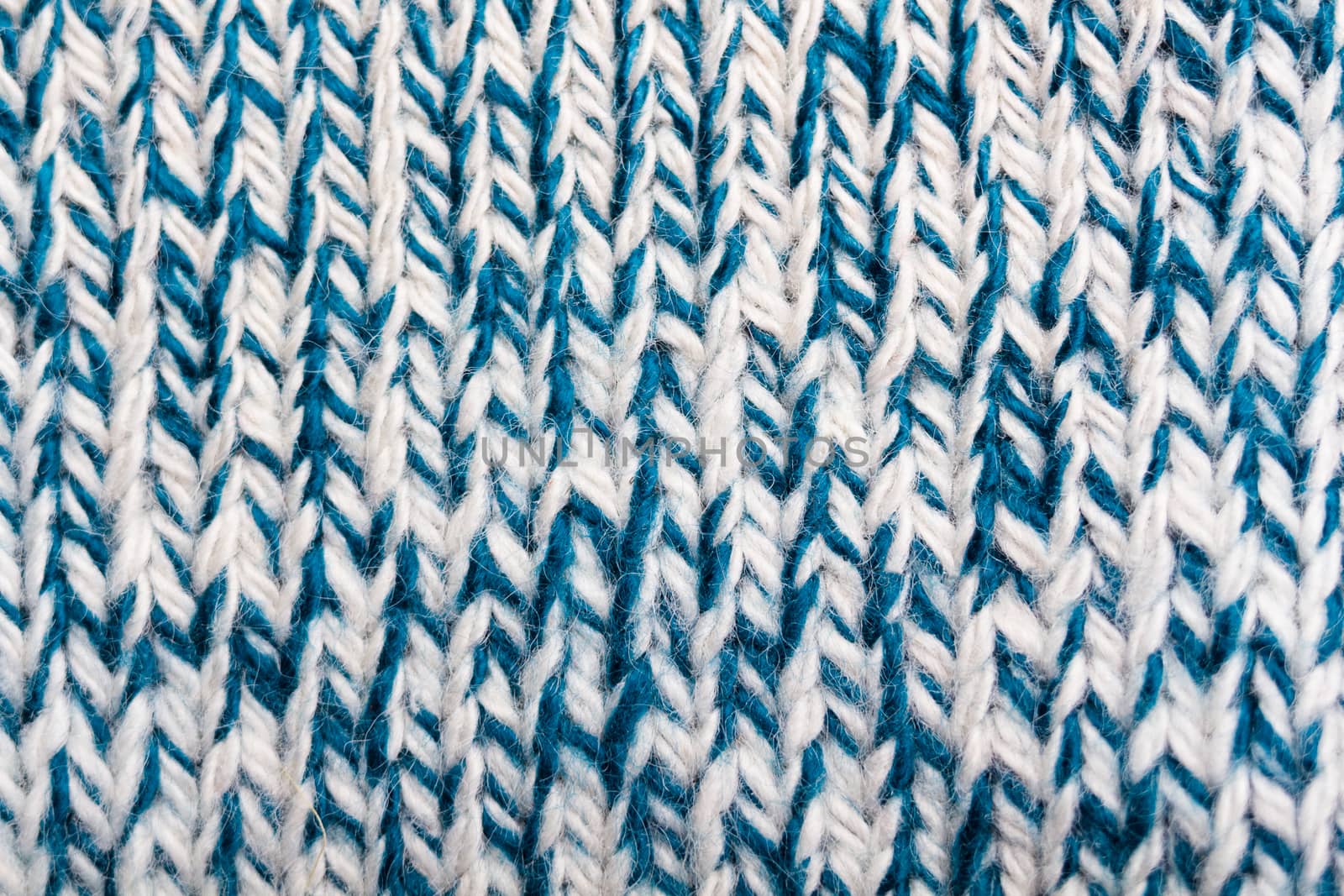 product of knitted white and blue woolen threads. macro