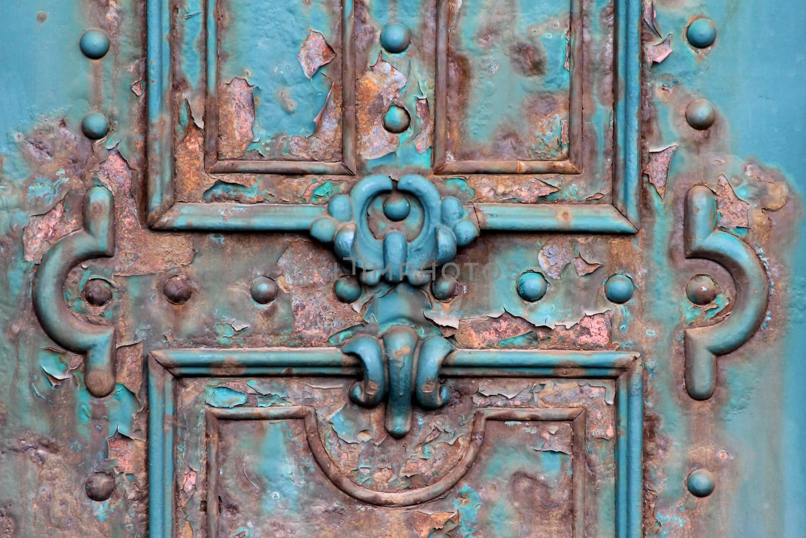 Ornate rusty iron gate close detail.