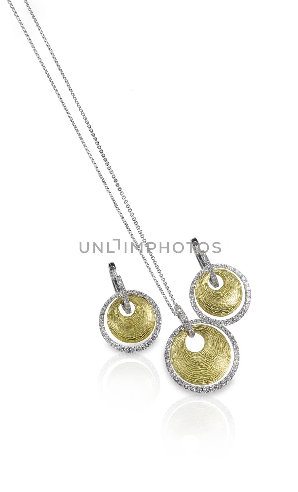 Diamond white and yellow gold fashion necklace and earring set isolated on white with a reflection