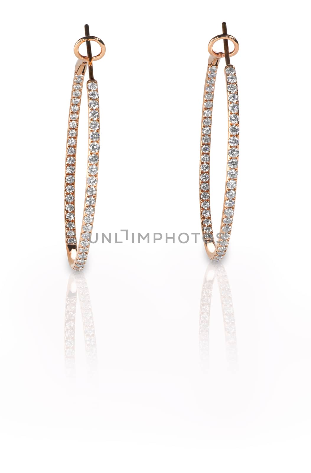 Pierced diamond hoop earrings in rose gold isolated on a white background with reflection