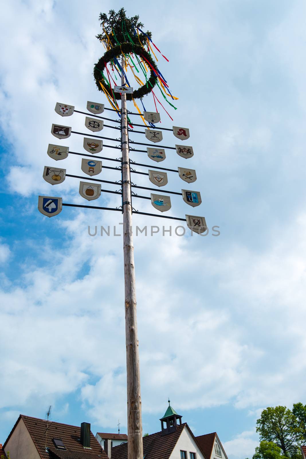OSTFILDERN-SCHARNHAUSEN, GERMANY - MAY 1, 2014 - A newly decorated and mounted maypole with plaques representing the various professions and crafts of the town celebrating the May Day on May, 1,2014 in Ostfildern-Scharnhausen near Stuttgart, Germany.