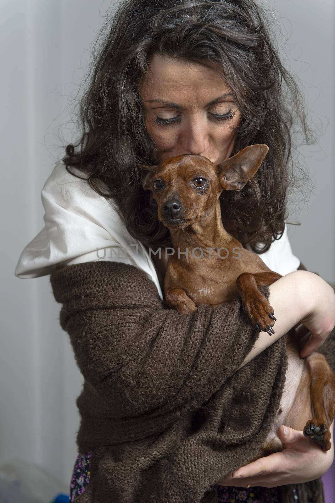 woman is holding her dog