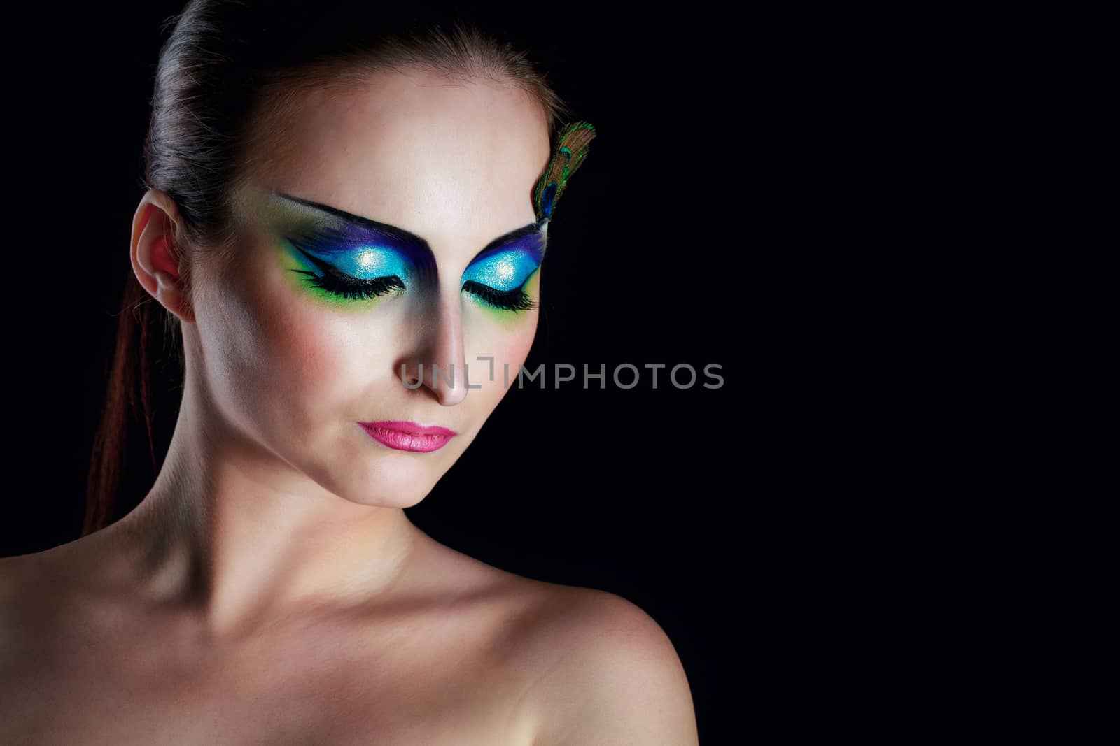 Attractive young girl with makeup peacock bird closeup portrait
