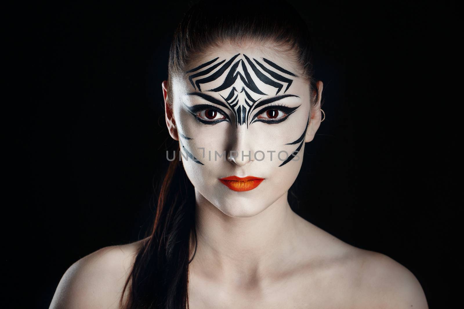 Attractive young girl with make-up of wild zebra close-up portrait