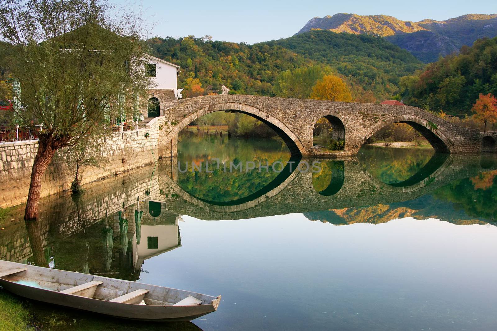 Arched bridge reflected in Crnojevica river, Montenegro, Balkans
