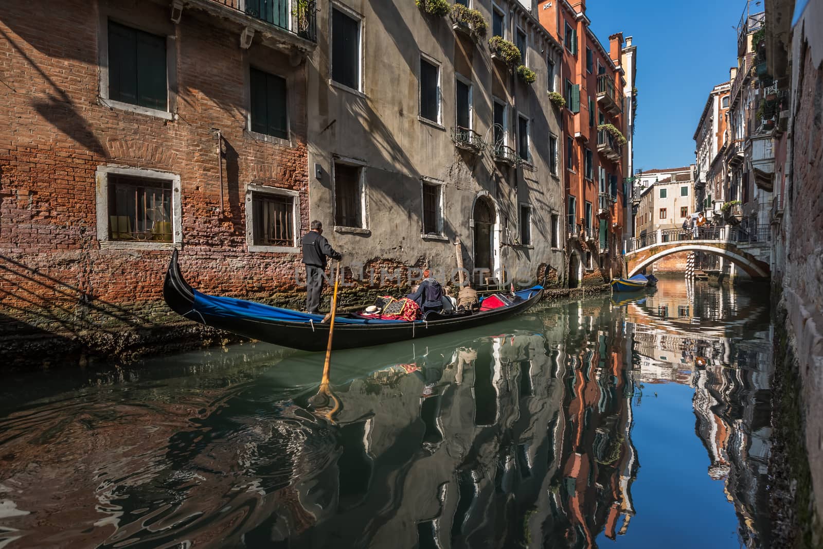 Traditional Venice Gandola Ride along Narrow Canal, Venice, Italy