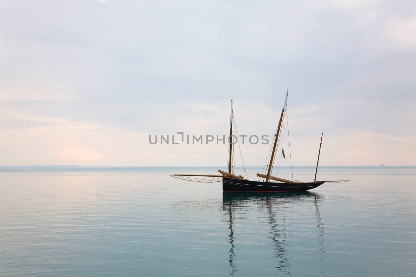 Old french ship bisquine in quiet water in Brittany