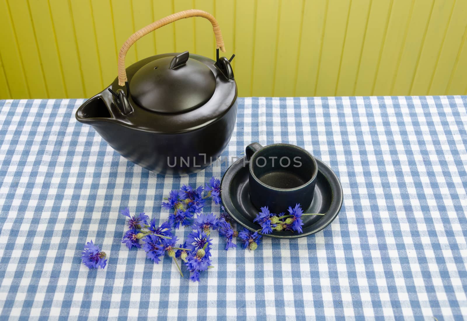 old retro ceramic tea set with fresh picked cornflower blossom on table