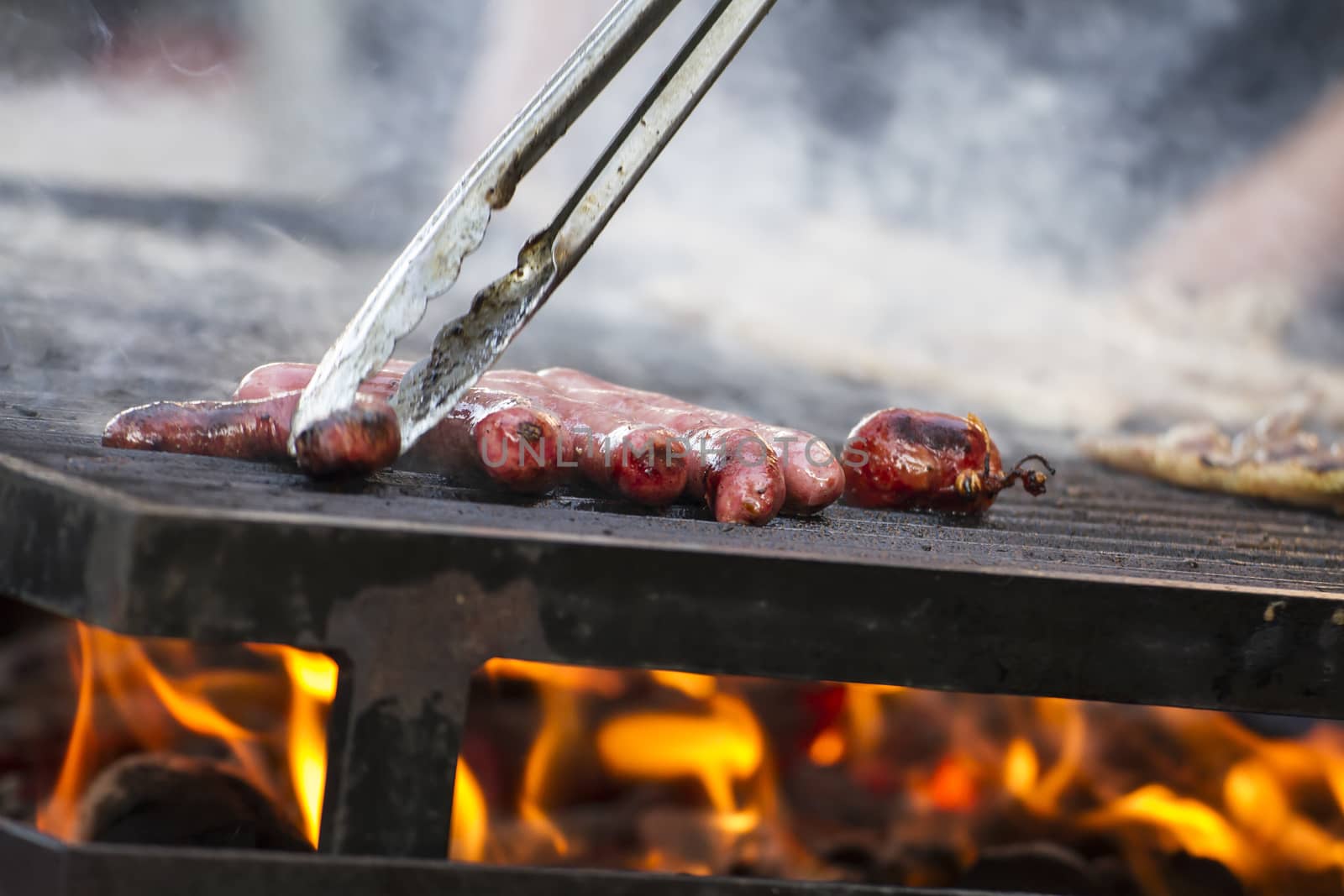 barbecue with sausages and lamb in a medieval fair, Spain by FernandoCortes