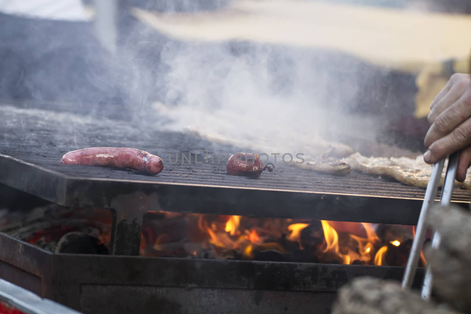 fire, barbecue with sausages and lamb in a medieval fair, Spain