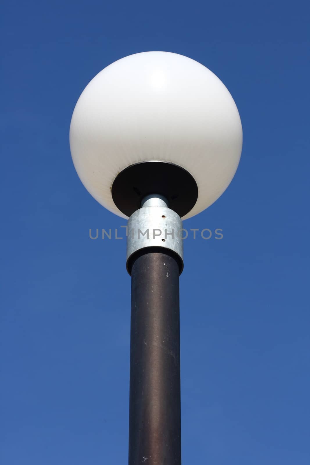 a street lamp with a large, spherical glass body