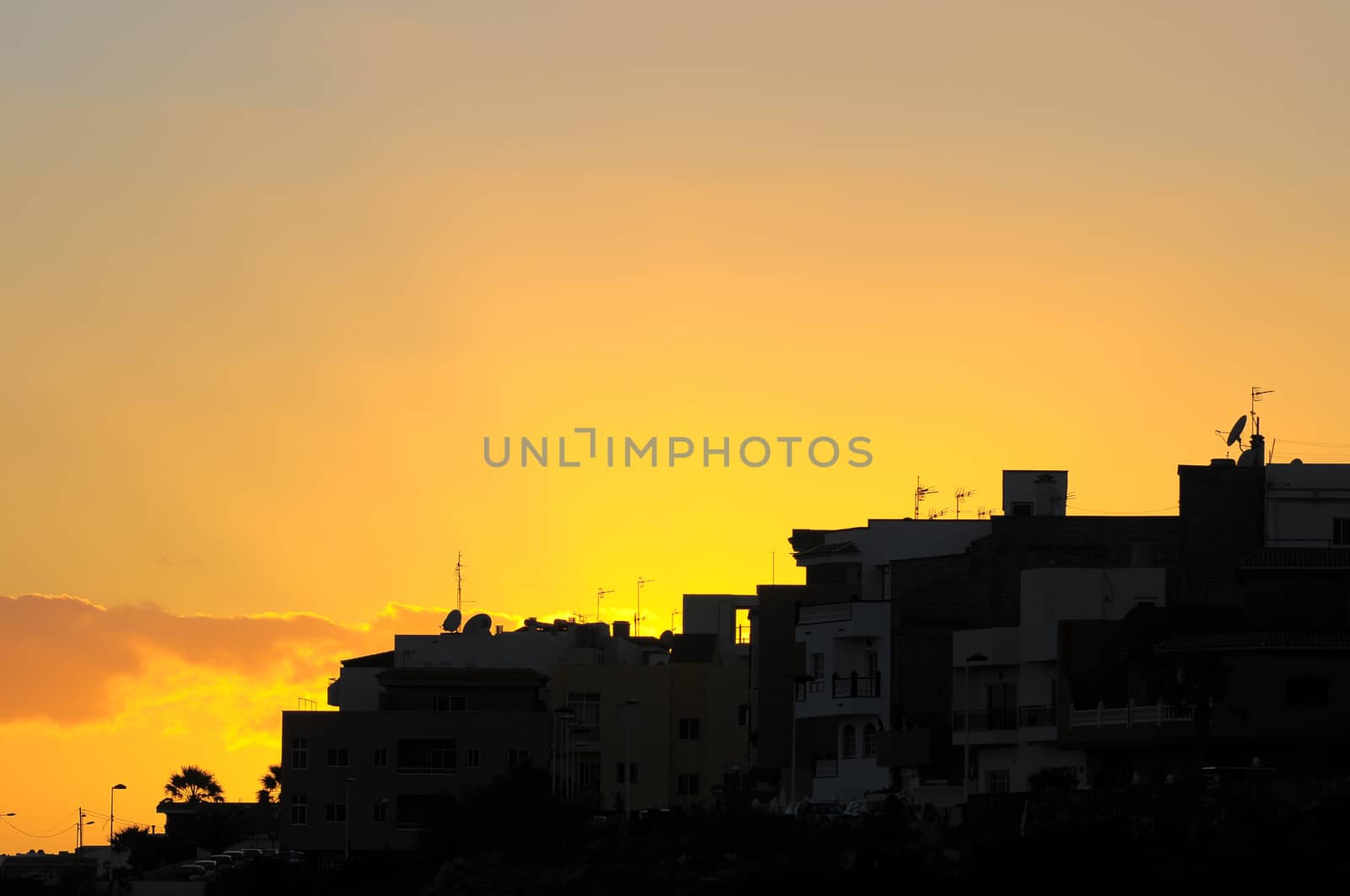 Silhouettes of Houses at Sunset over a Sea Village