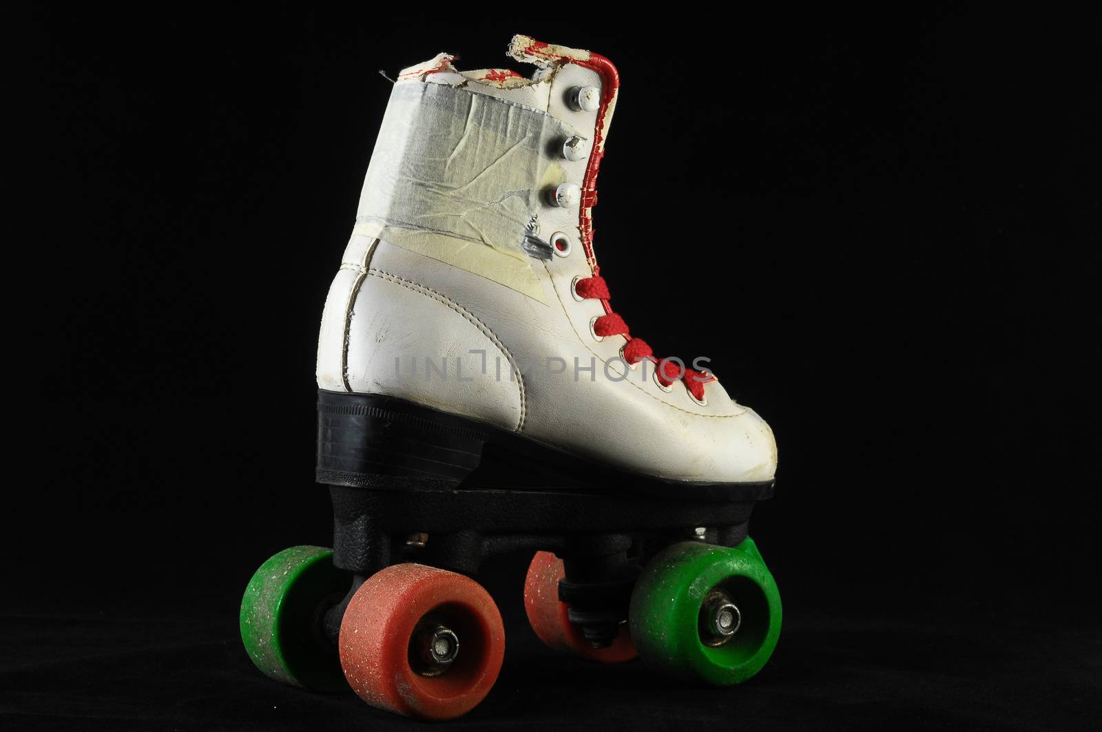 Used Vintage Consumed Roller Skate on a Black Background