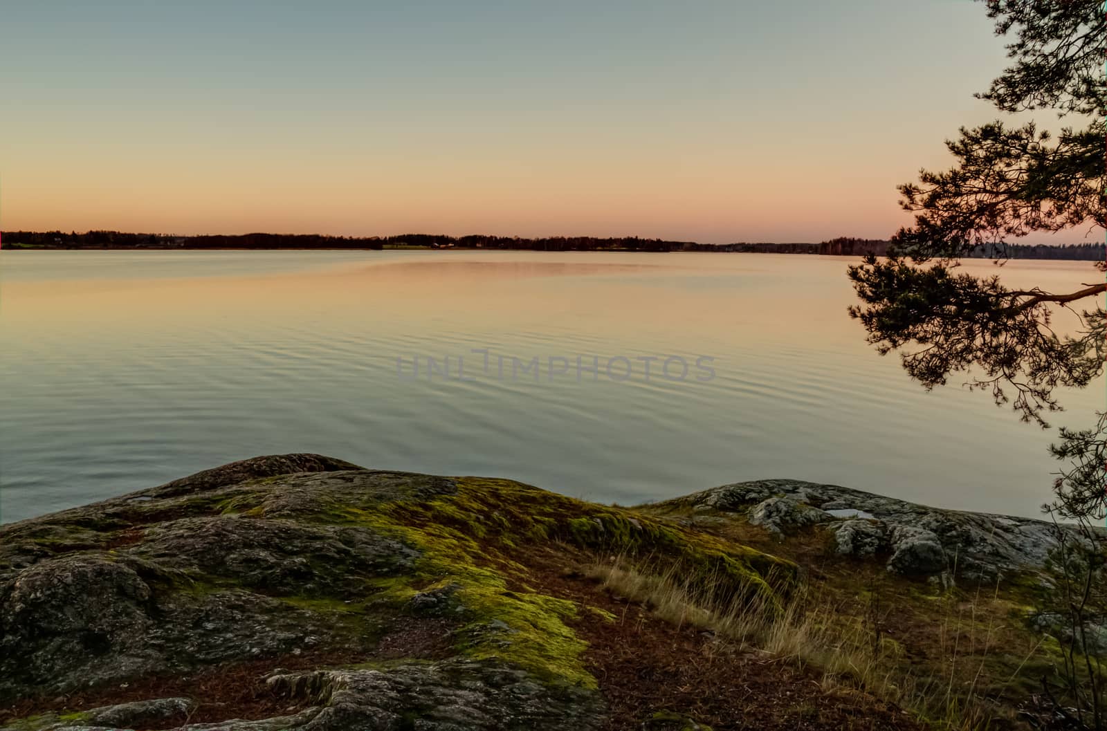 Scandinavian sunset from a rocky lakeshore