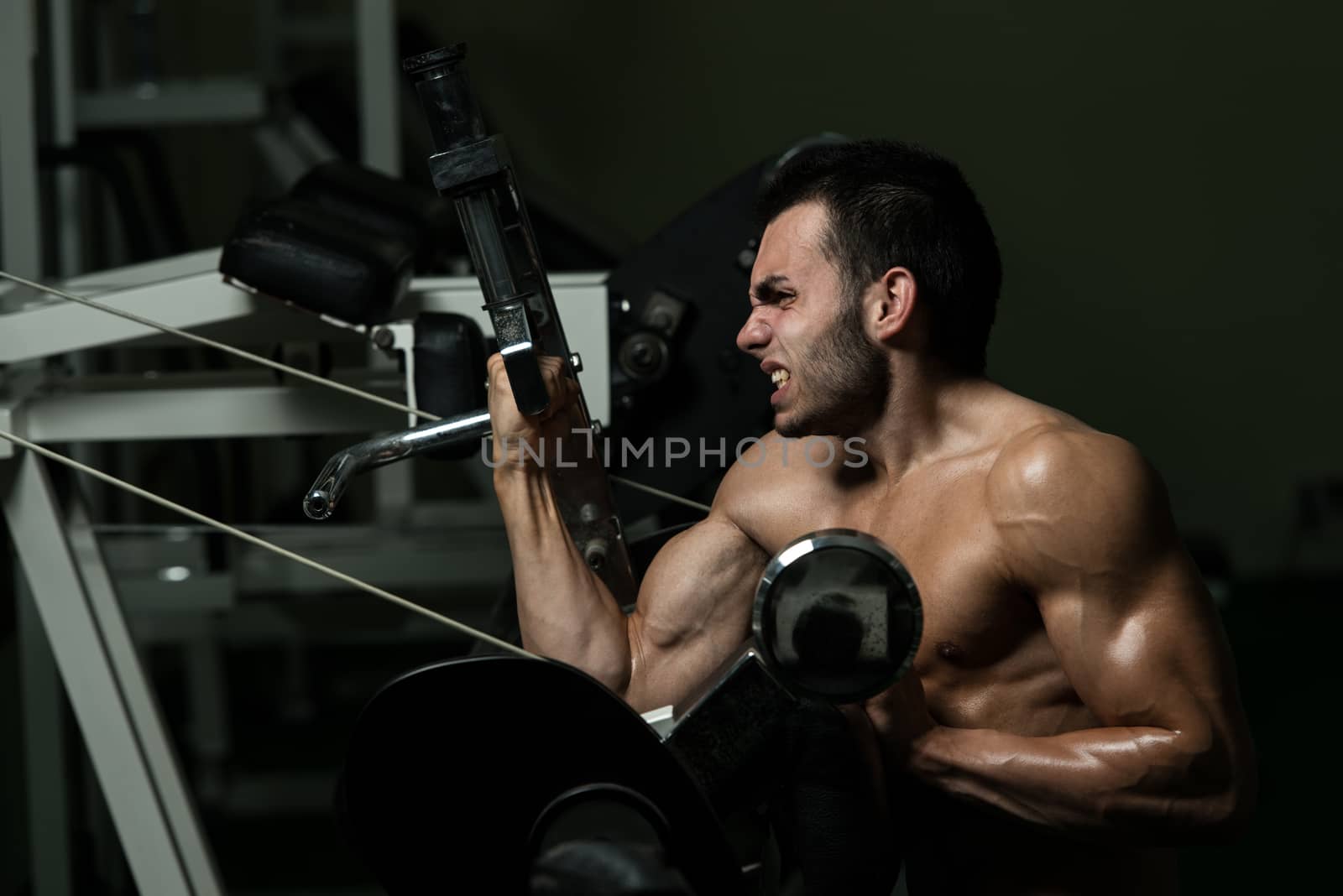 Young Man Doing Exercise For Biceps by JalePhoto