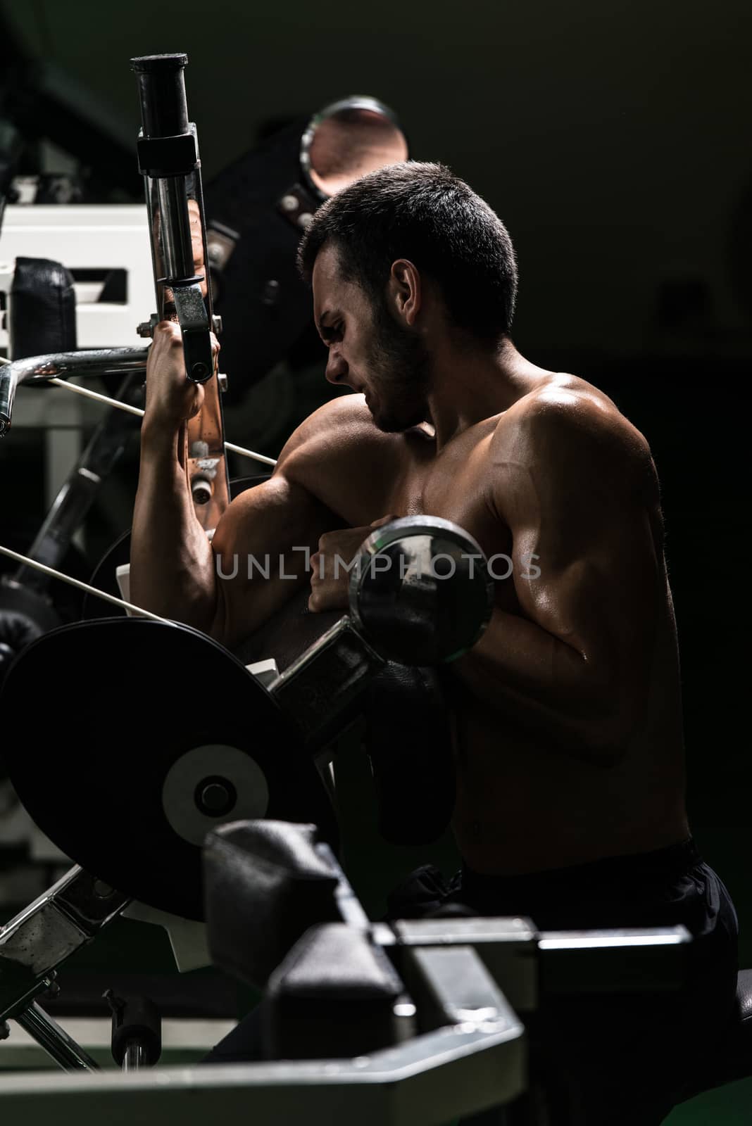 Young Man Working Out Biceps by JalePhoto