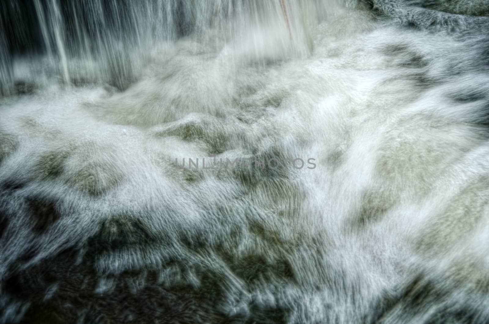 Dark water wave on the river with lot of foam.