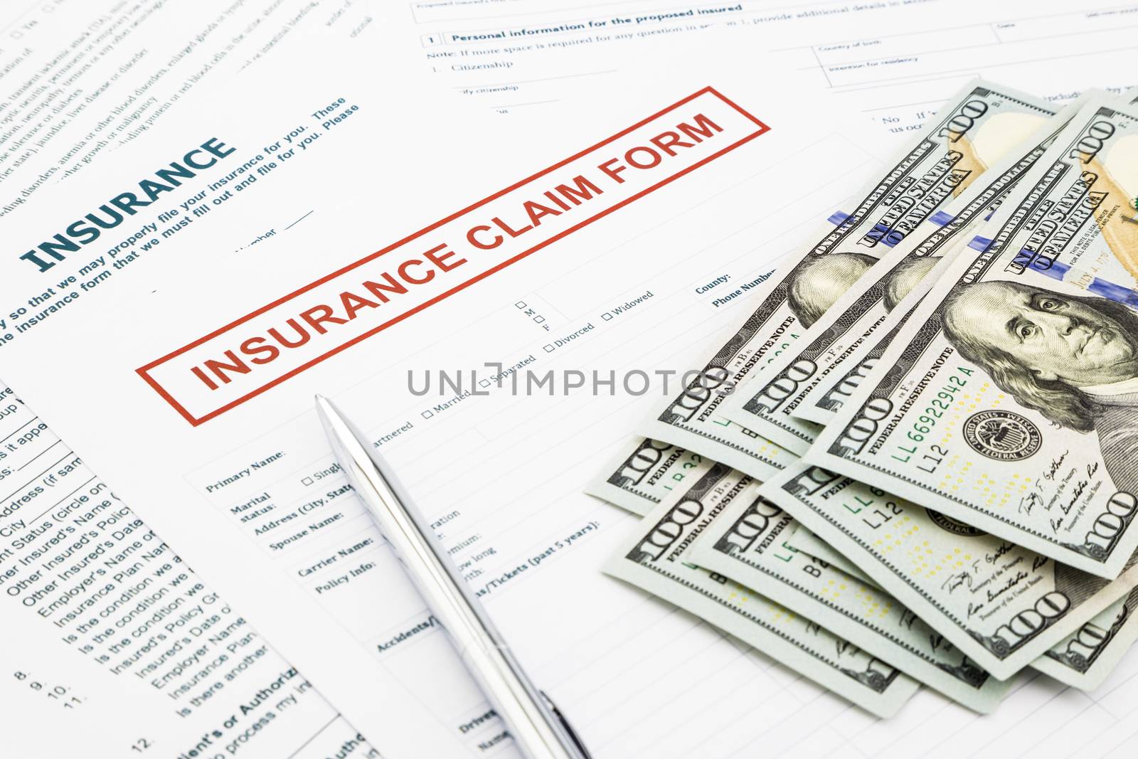 insurance claim form and money by vinnstock