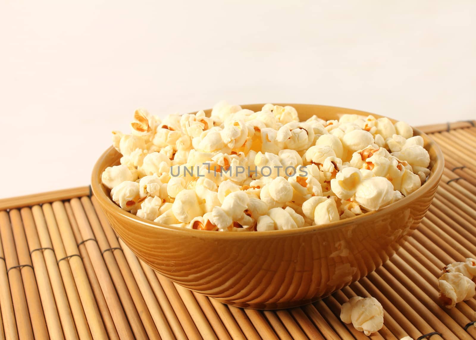popcorn in bowl isolated in white background by motionkarma