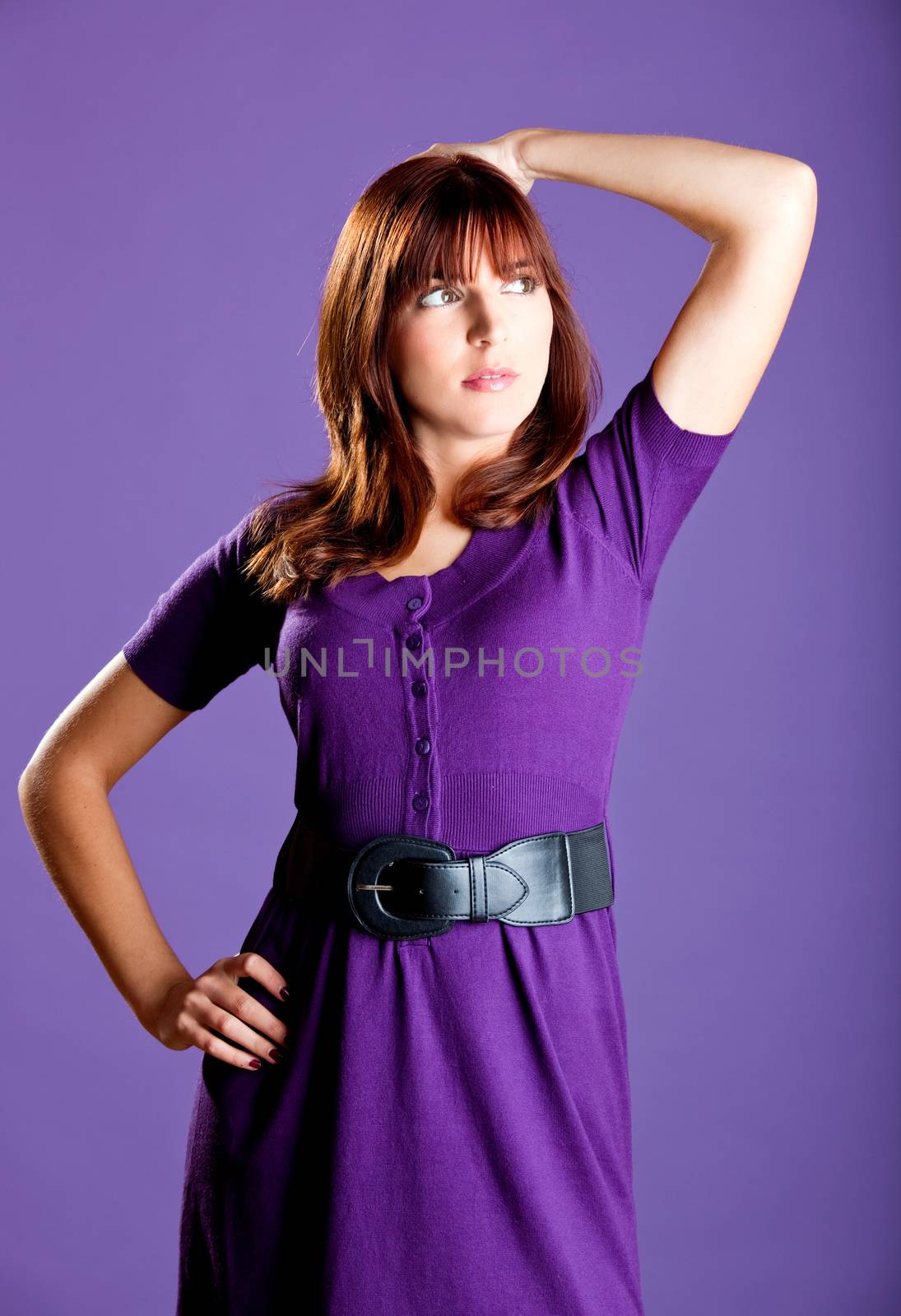 Portrait of a beautiful fashion woman over a violet background