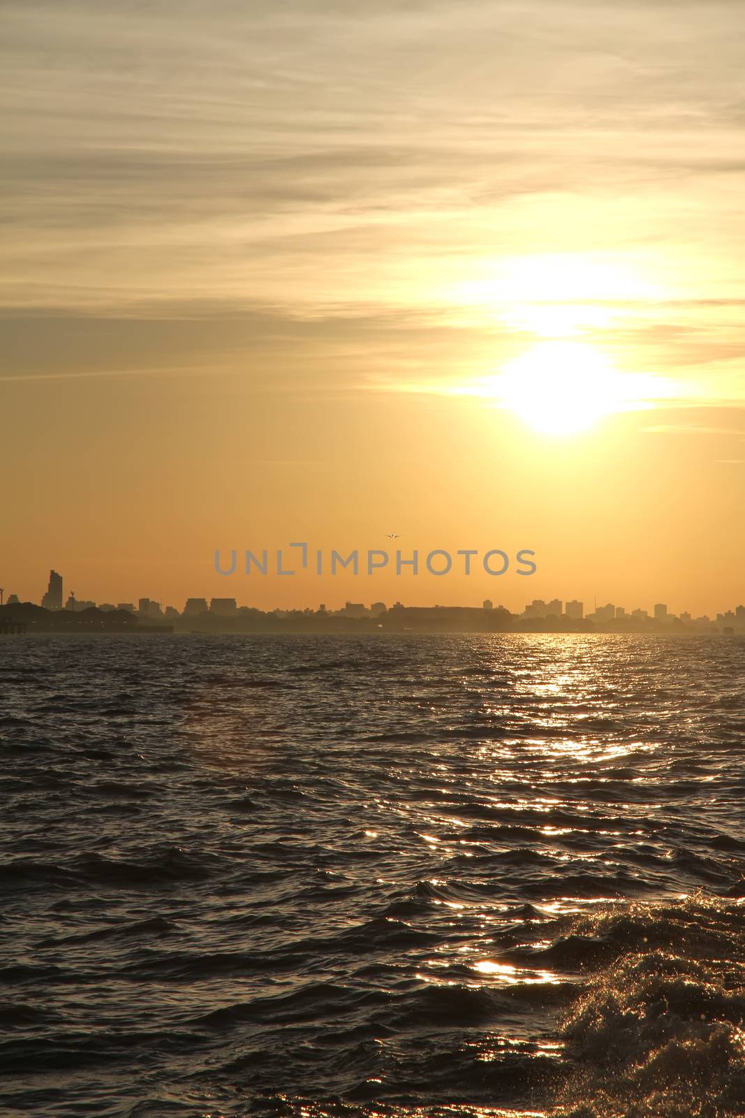 A sunset over the Rio de la Plata with the City of Buenos Aires in the background.