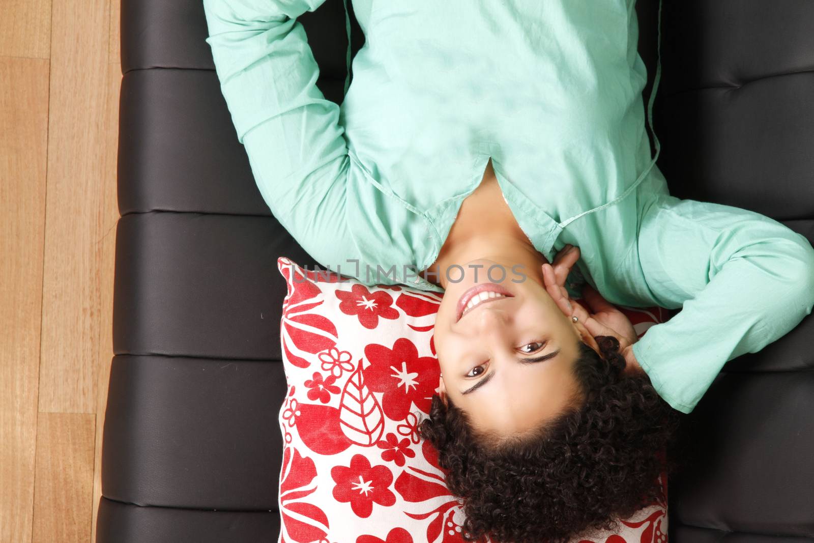 A jung brazilian woman relaxing on the sofa.