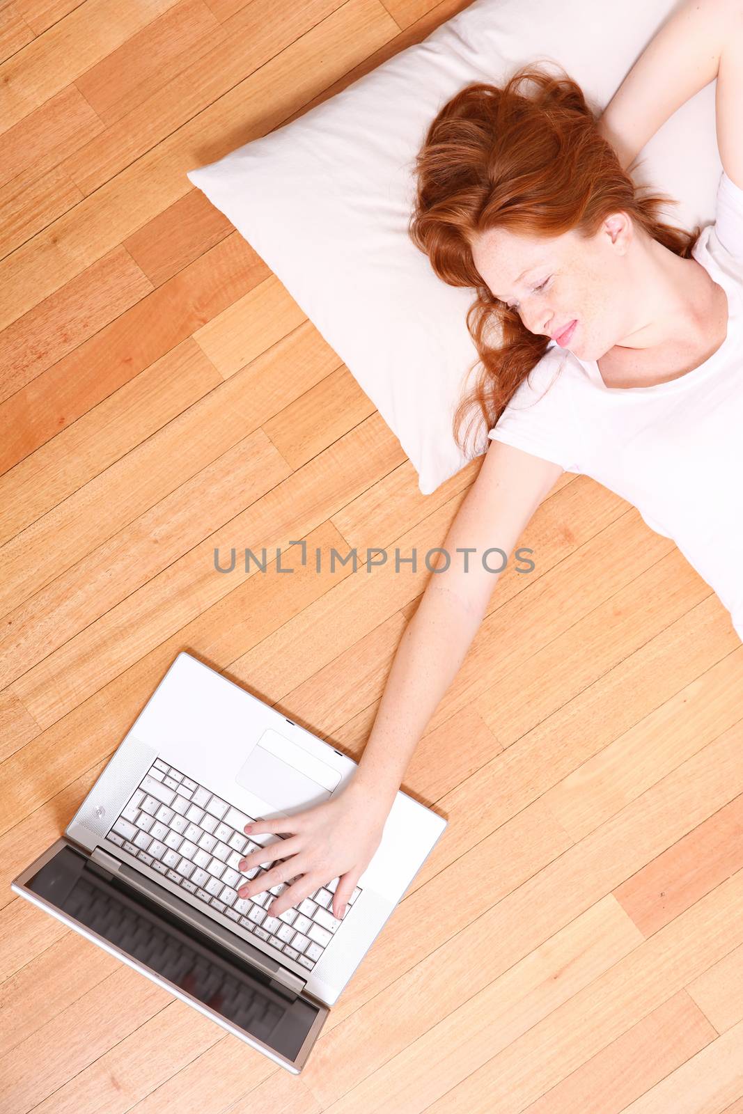 A young woman surfing on the Internet with a Laptop. 
