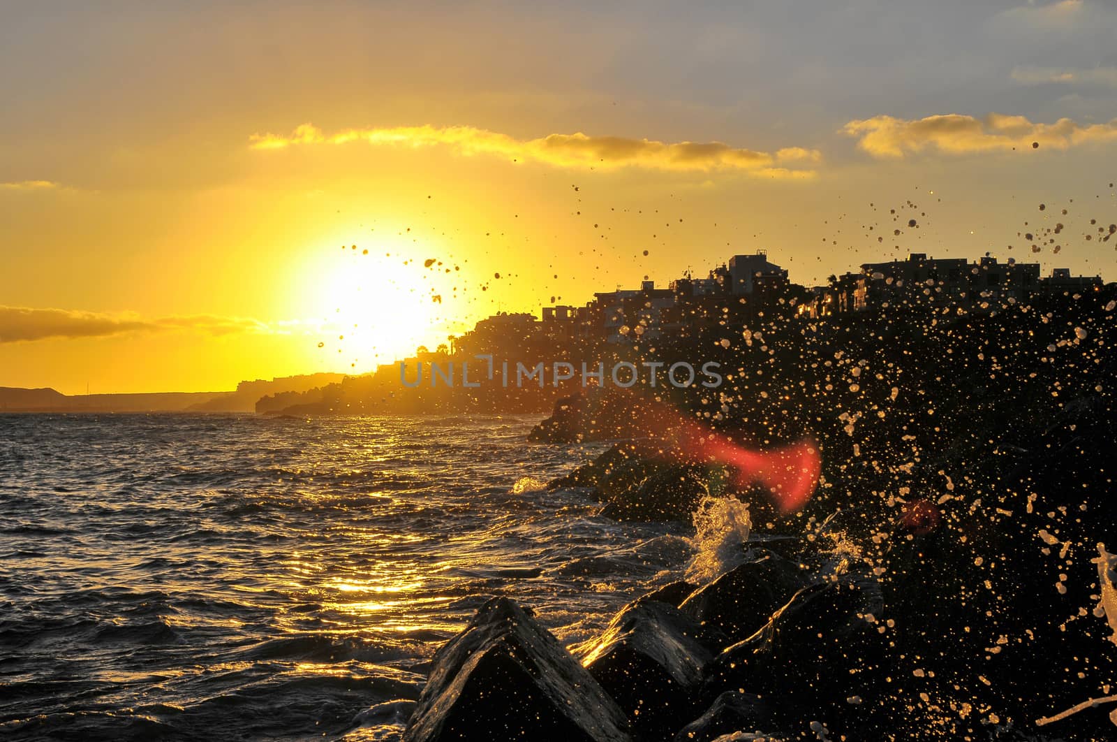 Silhouettes of Houses at Sunset over a Sea Village