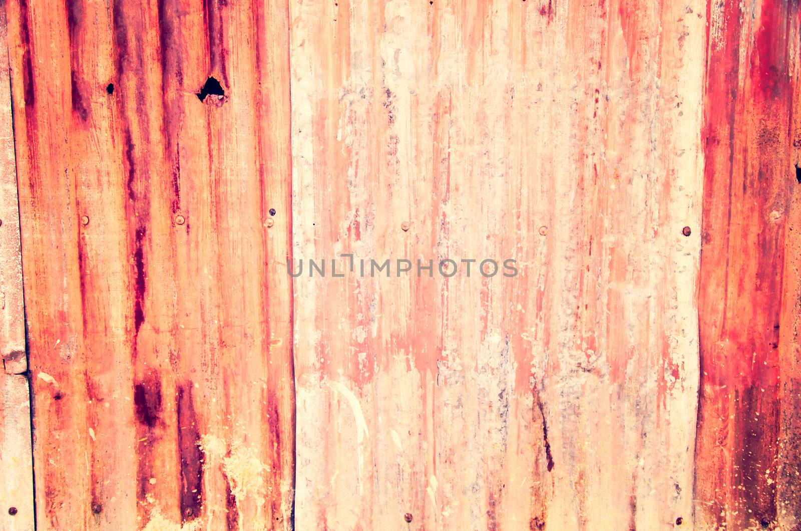 An abstract background image of rusty corrugated iron sheets  to form a wall or fence.