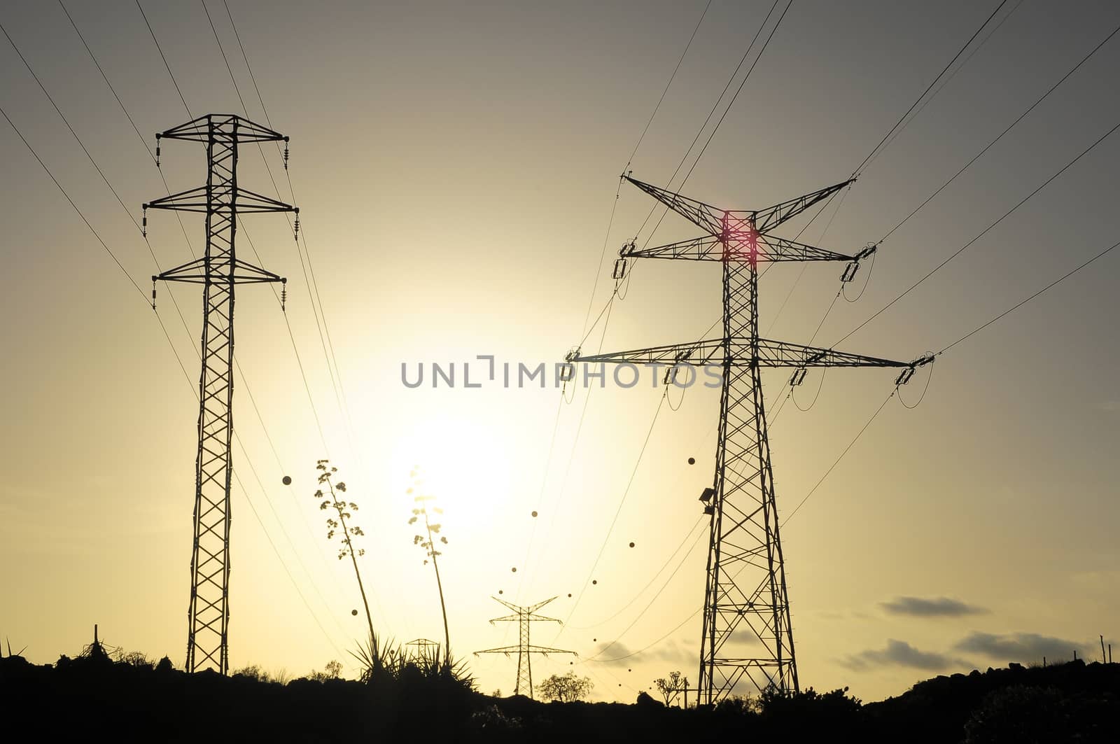 Electric Power Line Pylon over a colored Sunset