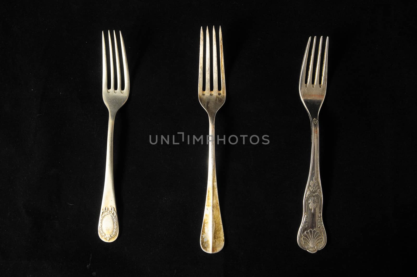 Ancient Vintage Silver Flatware on a Black Background