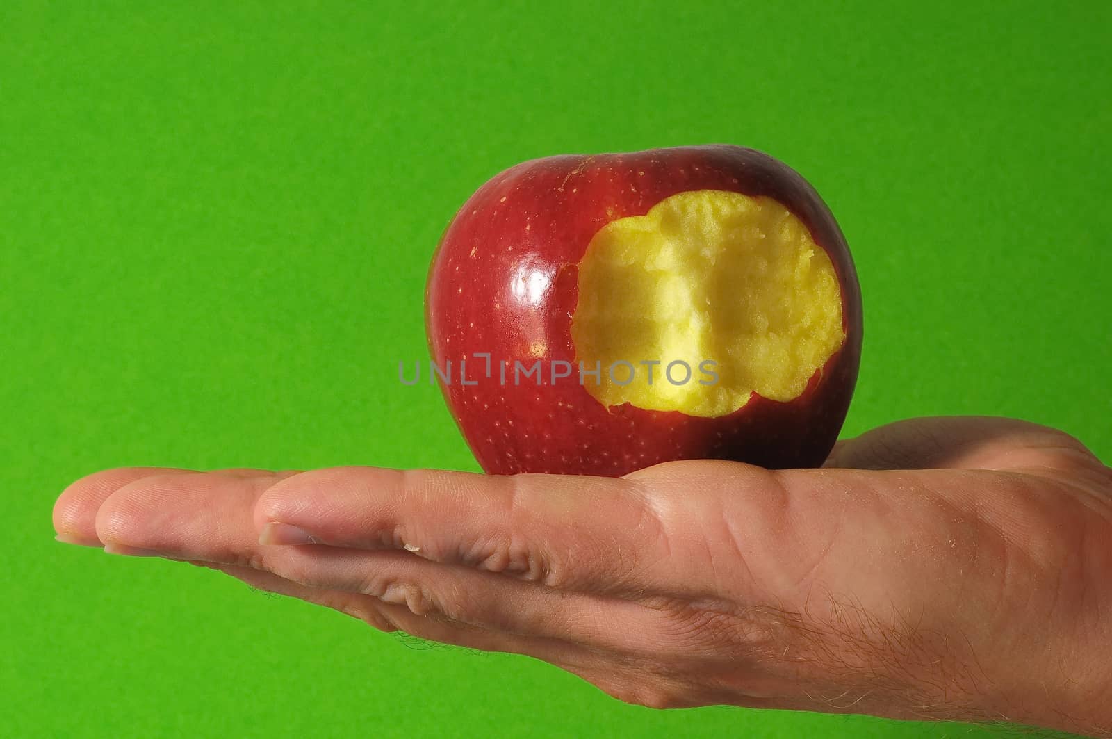 Bitten Red Apple Hand on a Colred Background