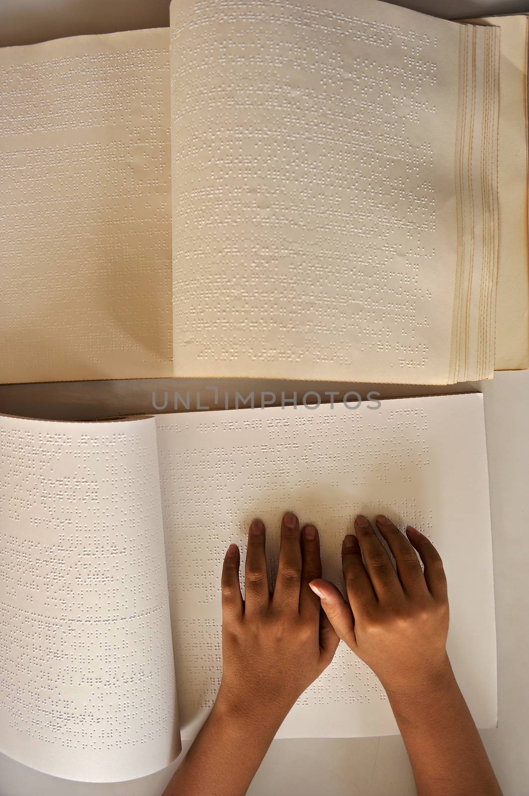 Blind reading text in braille language by think4photop
