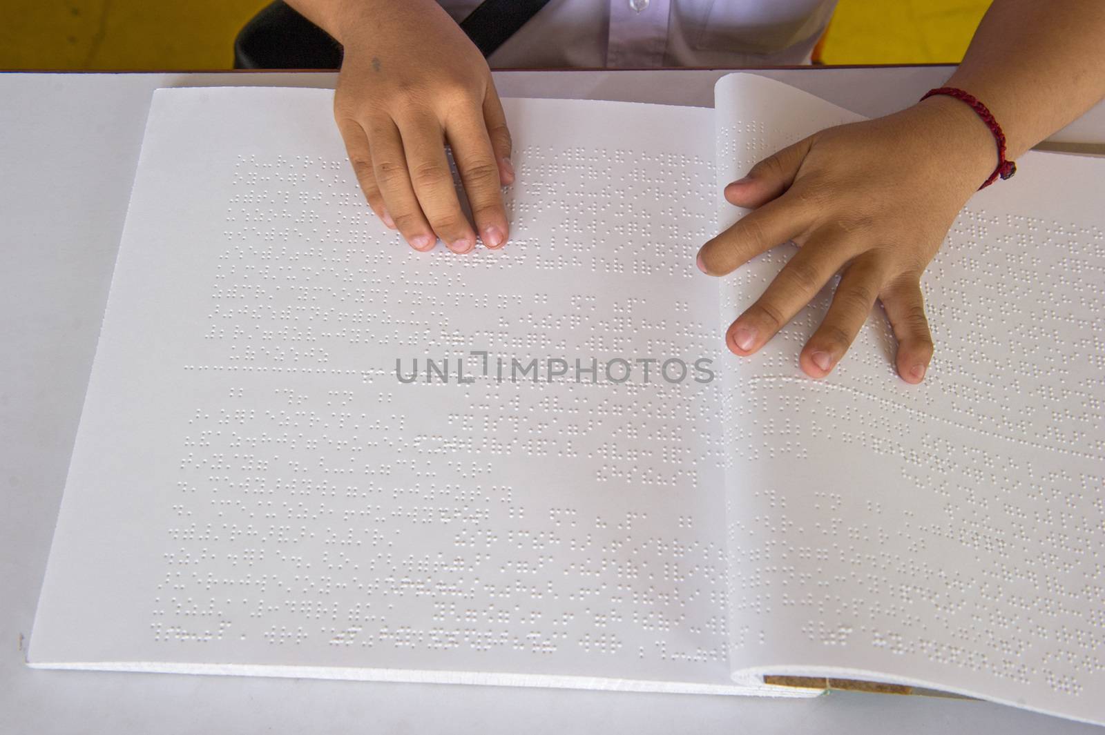 fingers and braille. blind people read a book in braille. by think4photop