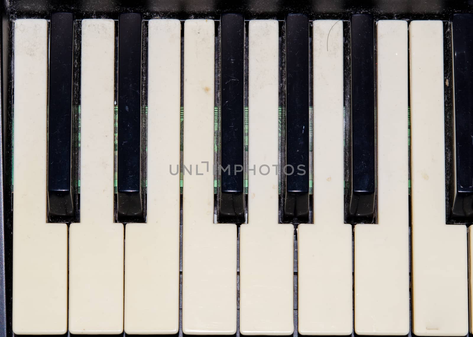 The image depicts the keyboard of a piano with a frontal perspective.