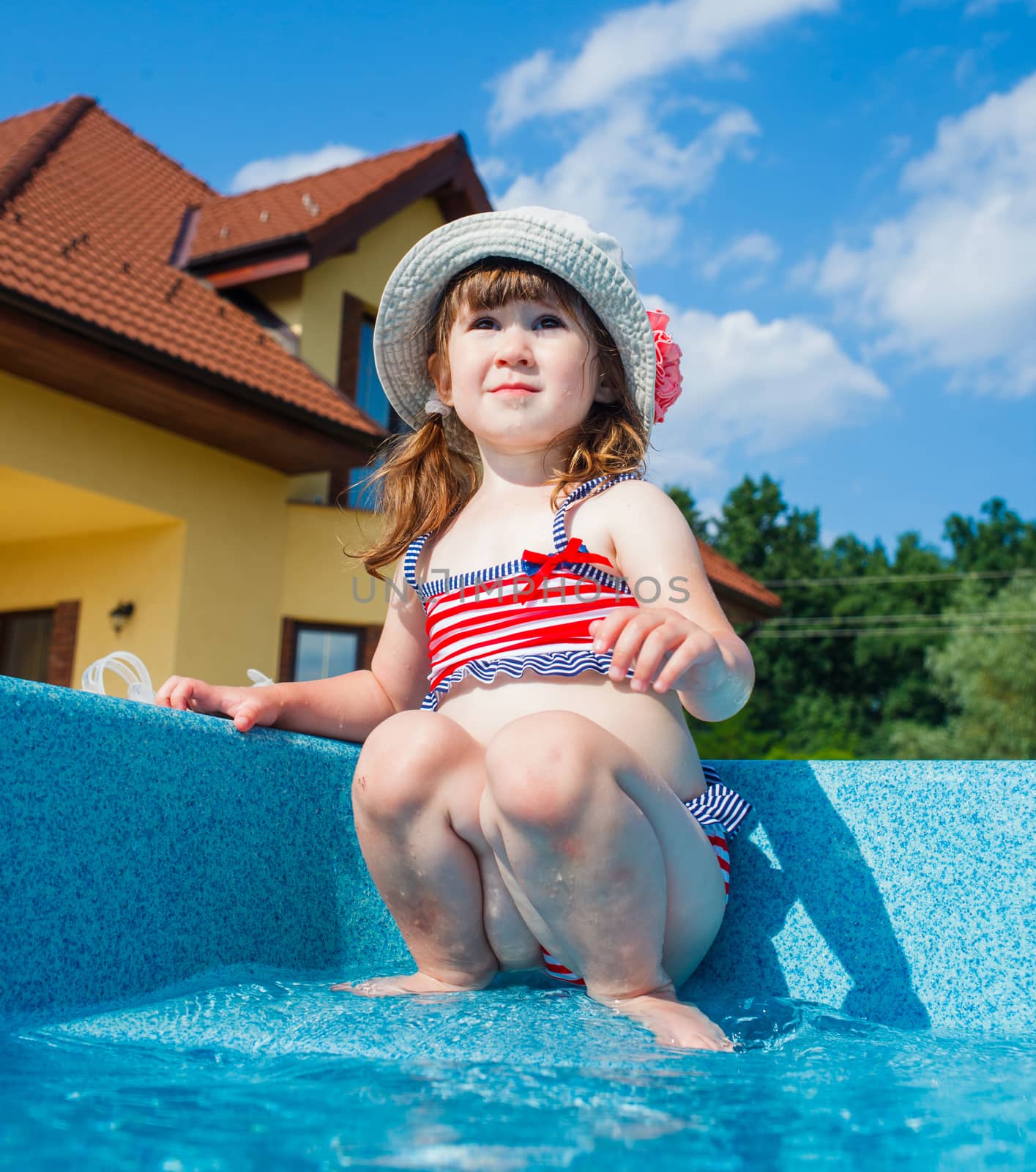 Cute little girl plaing in the pool