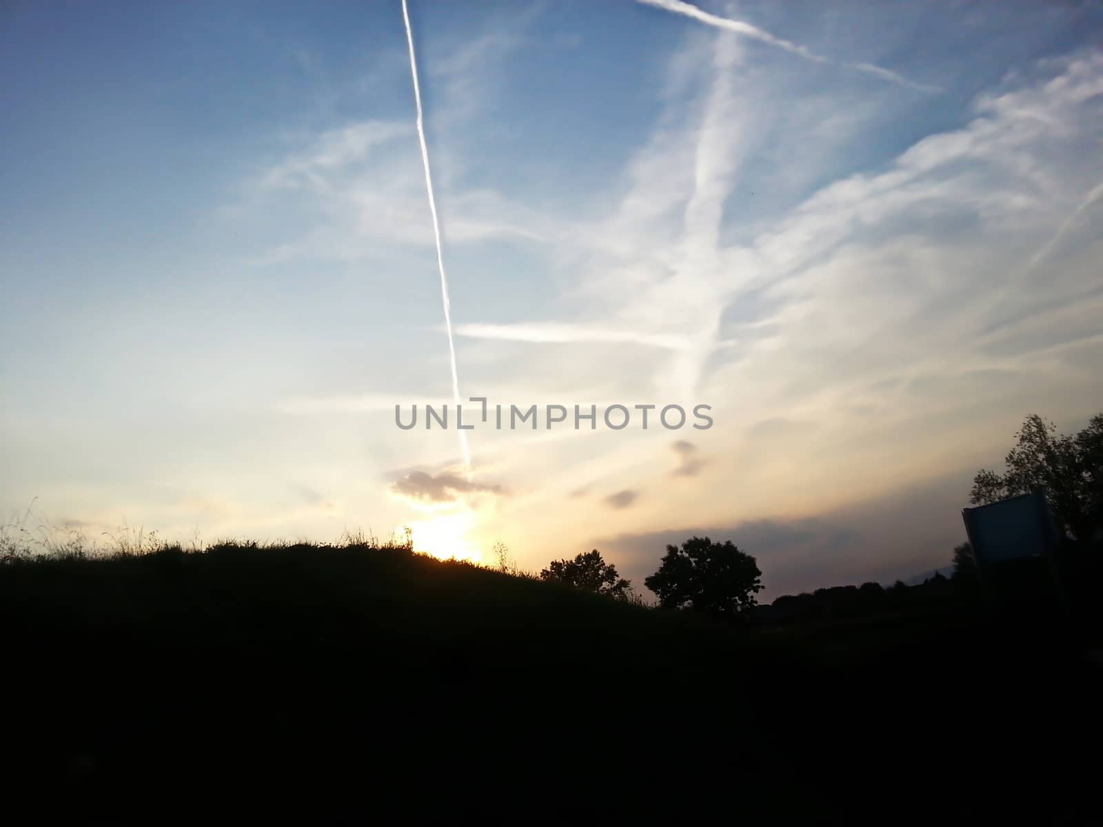 Beautiful sky trails in the backgroung with the foreground silhouette