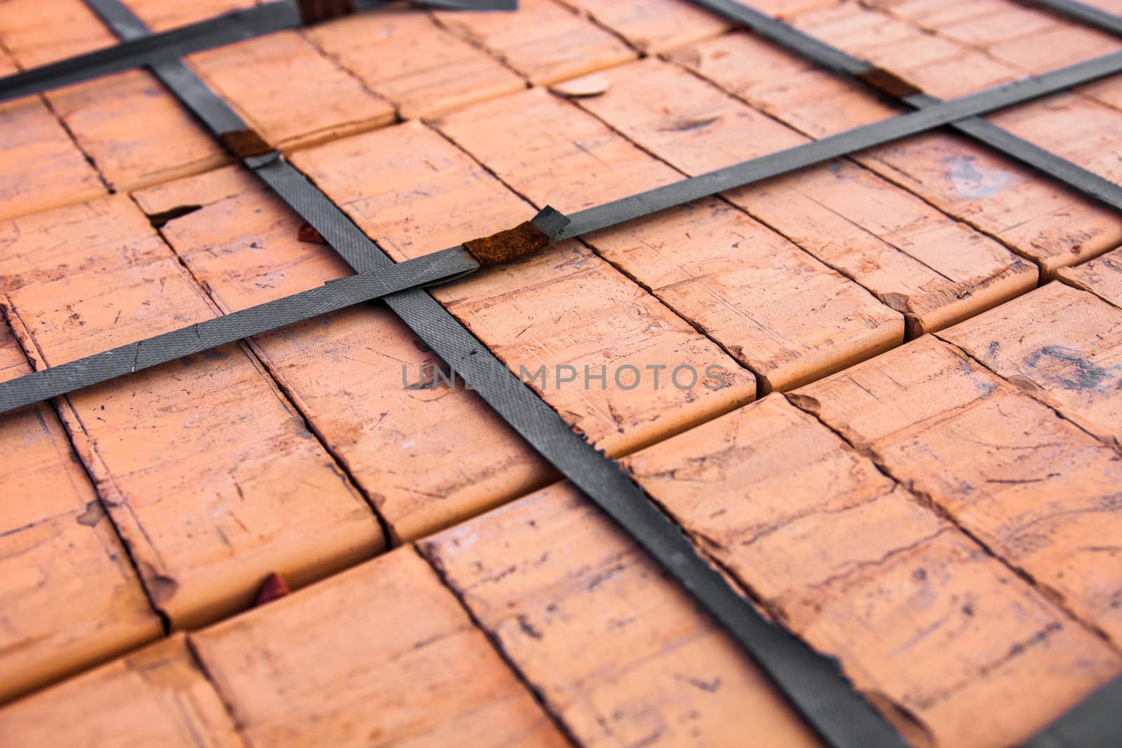 Stack of new silicate bricks tied-up with plastic stripe. Close-up.