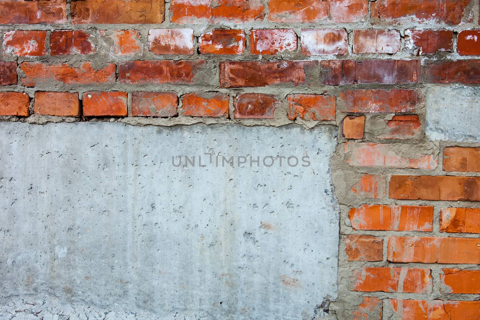 Brick wall with parts of concrete blocks by rootstocks